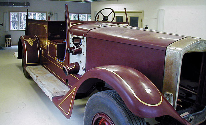 American LaFrance Senior 400 restoration in Fire Gold shop with gilding in progress.